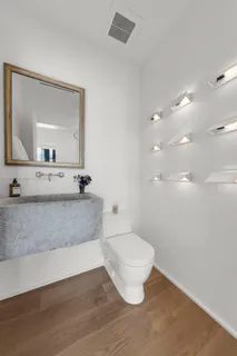 a view of bathroom with toilet sink and mirror