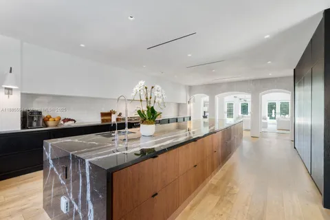 a kitchen with stainless steel appliances granite countertop a sink counter space and a center island