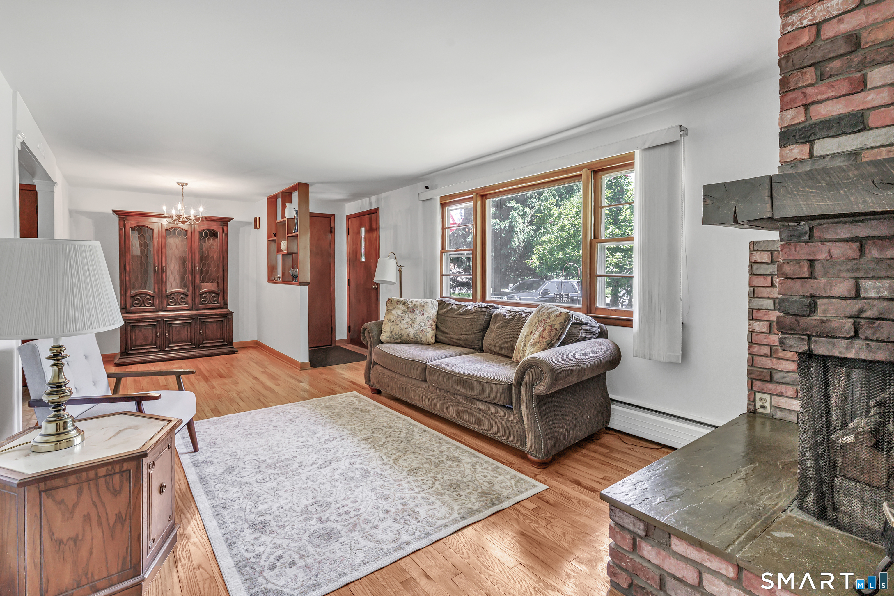 223 Wheeler Road Monroe, CT 06468 - Photo 5 of 35 a living room with furniture and a fireplace