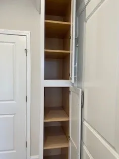 a view of walk in closet with empty racks