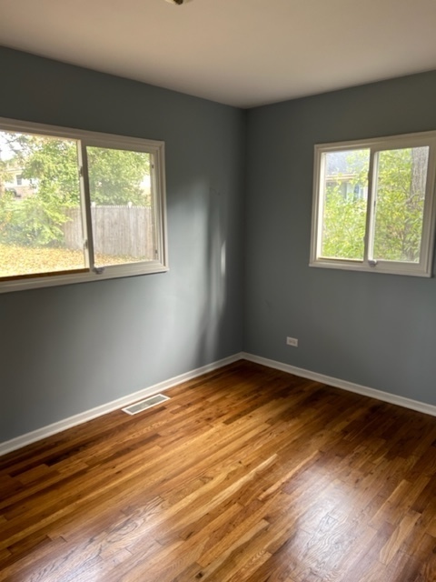 200 Flagstaff Lane Hoffman Estates, IL 60169 - Photo 15 of 19 a view of an empty room with wooden floor and a window
