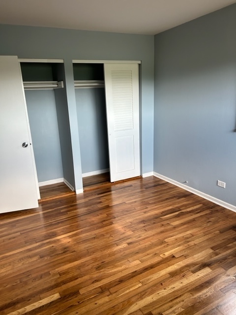 200 Flagstaff Lane Hoffman Estates, IL 60169 - Photo 16 of 19 an empty room with wooden floor and closet