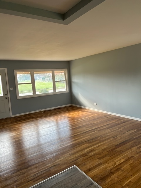 200 Flagstaff Lane Hoffman Estates, IL 60169 - Photo 4 of 19 an empty room with wooden floor and windows