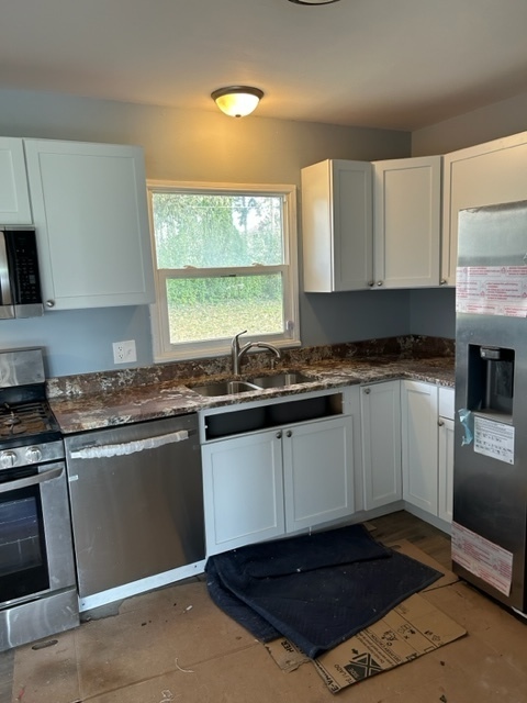 200 Flagstaff Lane Hoffman Estates, IL 60169 - Photo 6 of 19 a kitchen with granite countertop a sink cabinets and stainless steel appliances
