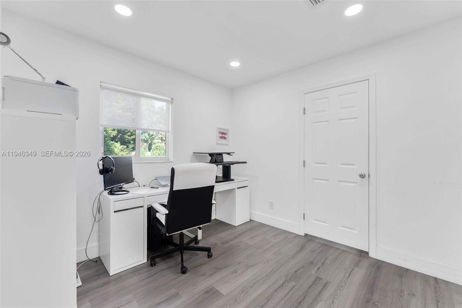 195 Northwest 115th Street Miami, FL 33168 - Photo 15 of 27 a view of a workspace with furniture and a window