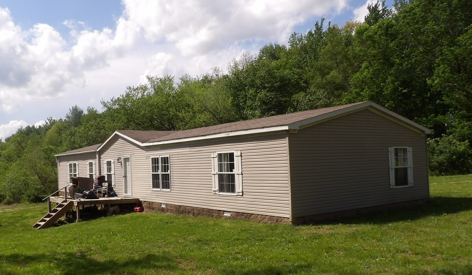 259 Three Mile Creek Road Rosiclare, IL 62982 - Photo 2 of 4 a view of a house with a yard and sitting area