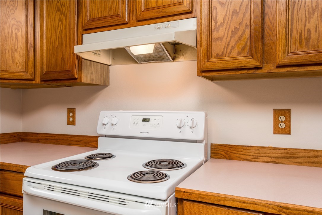 1320 Coal Creek Road Longview, WA 98632 - Photo 12 of 34 a kitchen with a stove and a microwave