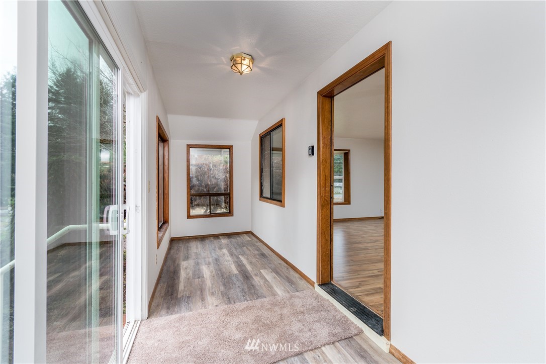 1320 Coal Creek Road Longview, WA 98632 - Photo 6 of 34 a view of a hallway with wooden floor and a living room