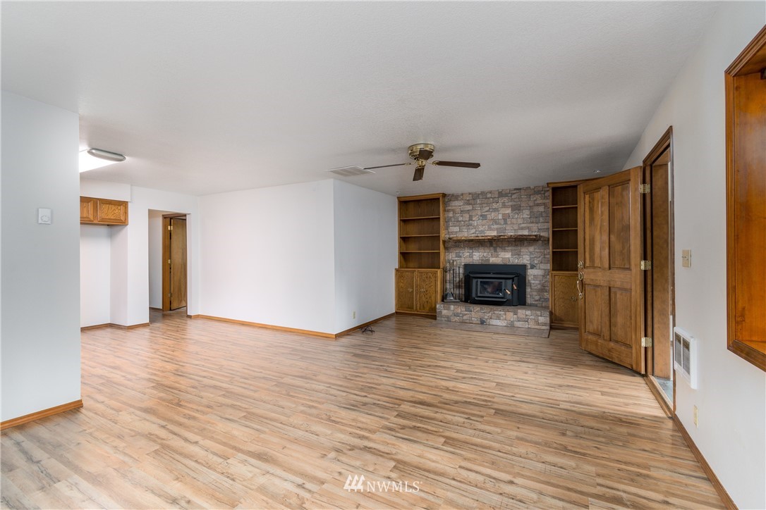 1320 Coal Creek Road Longview, WA 98632 - Photo 8 of 34 a view of a livingroom with a fireplace and wooden floor