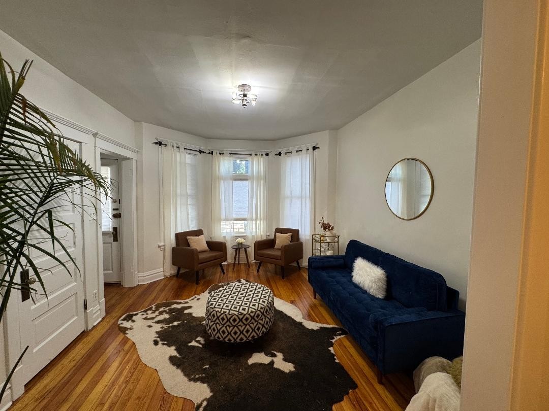 1831 West Nelson Street, Unit 1 Chicago, IL 60657 - Photo 2 of 11 a living room with furniture rug and wooden floor