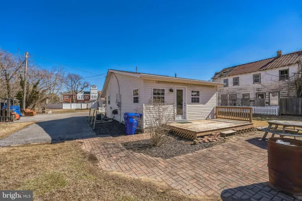 a front view of house with yard space and seating