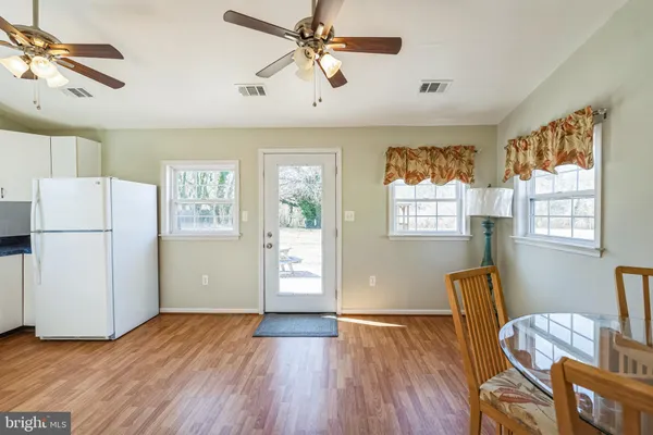a view of kitchen with furniture wooden floor and window