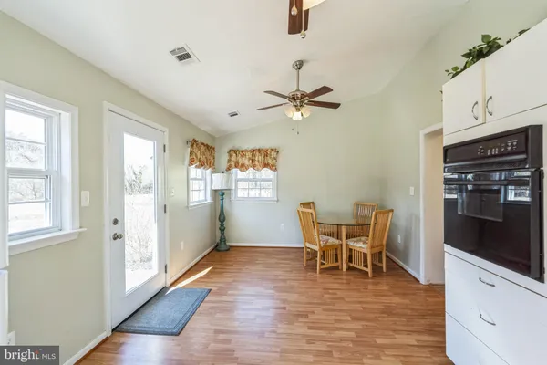 a view of a dining room with furniture window and wooden floor