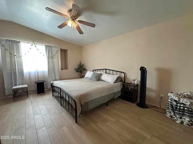 a bedroom with a bed and a chandelier