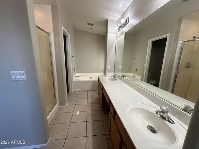 a bathroom with a tub shower and sink