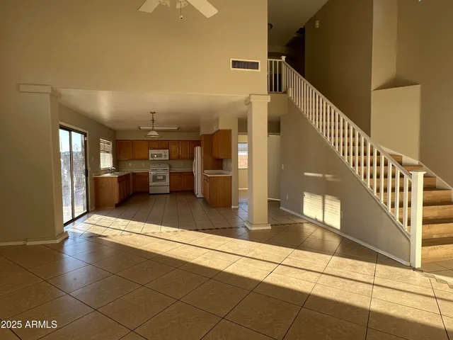 a view of kitchen with sink and refrigerator