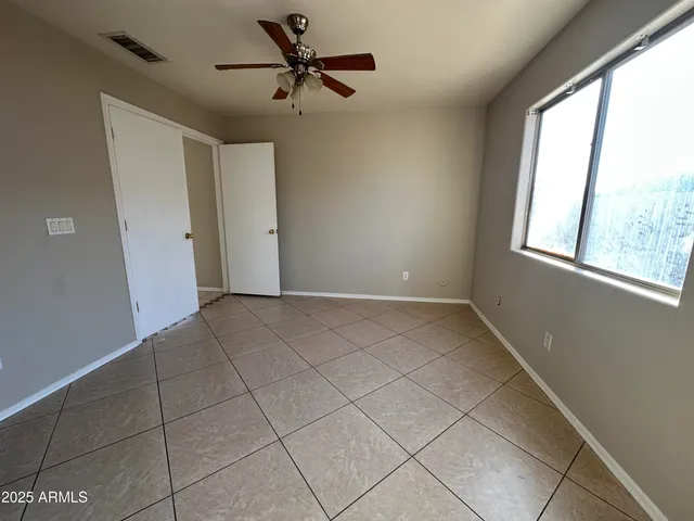 a view of a livingroom with a ceiling fan and window
