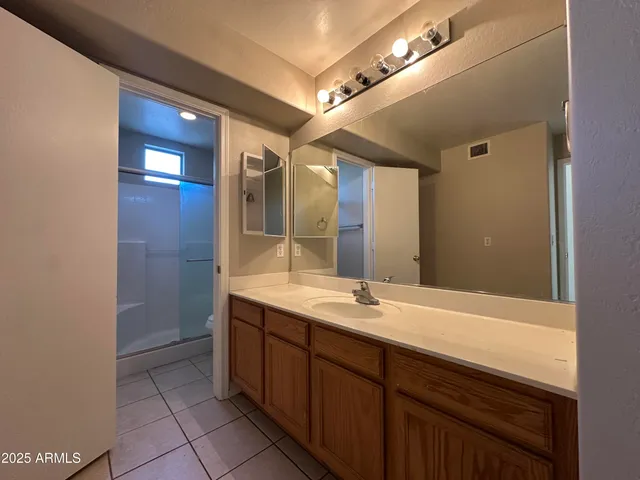 a spacious bathroom with a double vanity sink and a mirror