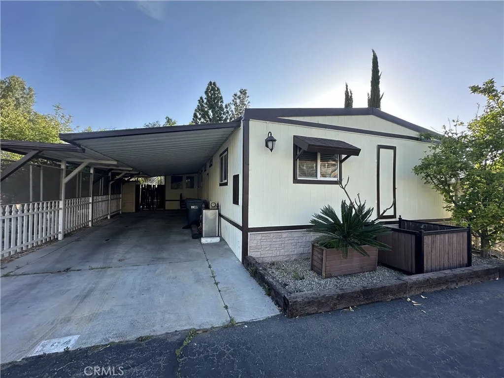 a view of a house with a porch and potted plants