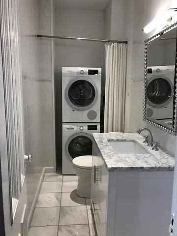 a utility room with sink dryer and washer