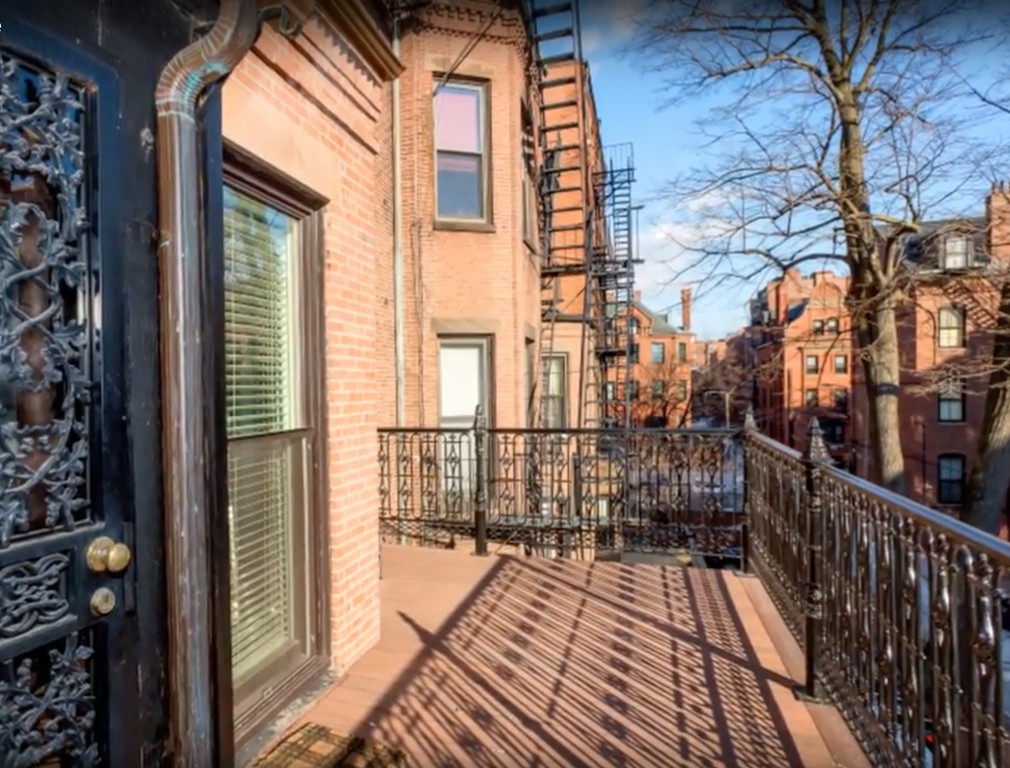 365 Beacon Street, Unit 2 Boston, MA 02116 - Photo 9 of 15 a view of a balcony with wooden floor and fence