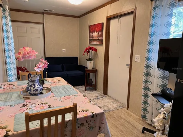 a dining room with furniture and wooden floor