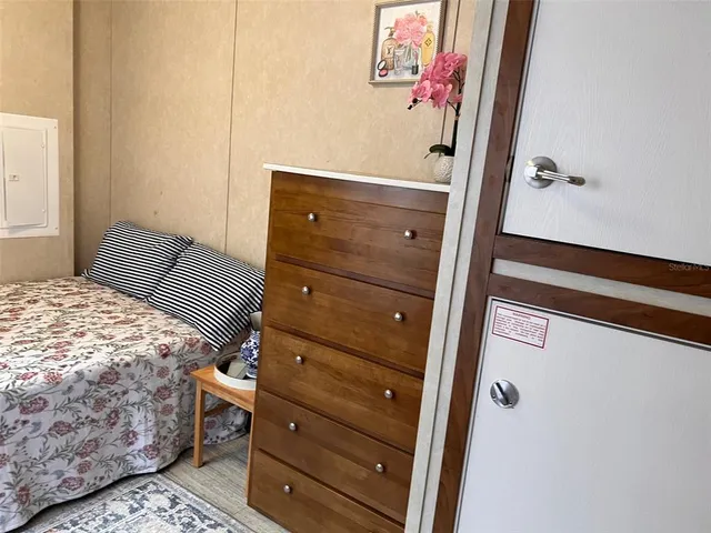 a bedroom with a bed and a dresser