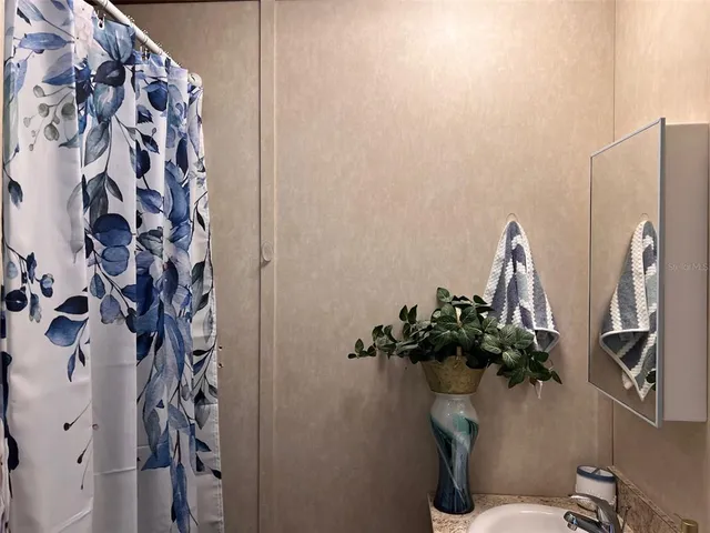 a bathroom with a toilet and a shower curtain