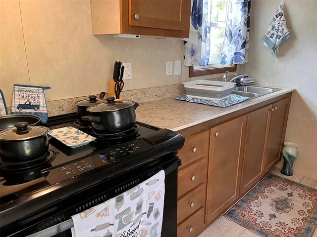 a kitchen with a stove and a sink