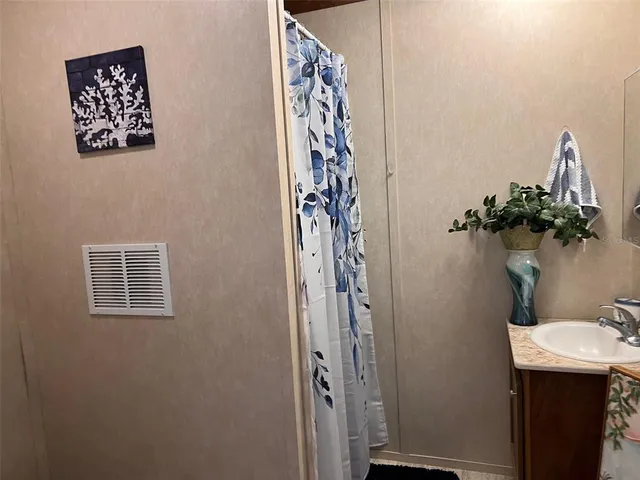a bathroom with a sink and mirror with toilet