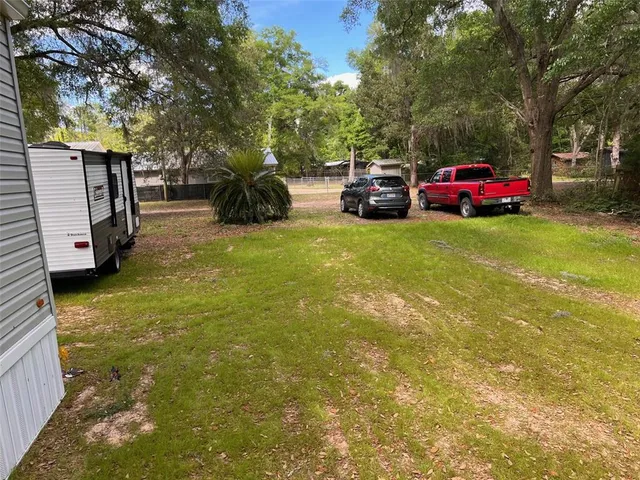 a view of a yard with car parked