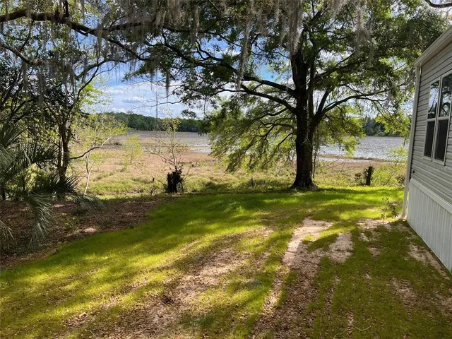 a view of a yard with swimming pool