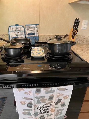 a stove top oven sitting inside of a kitchen