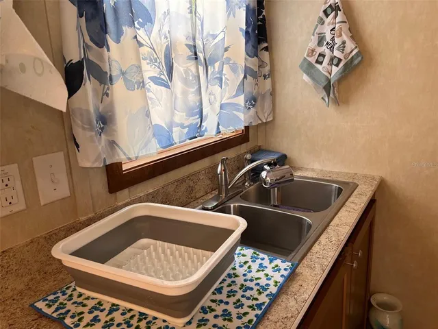 a close view of a sink a counter and utility