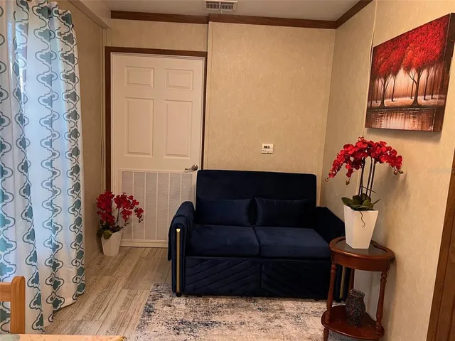 a living room with furniture and flowers