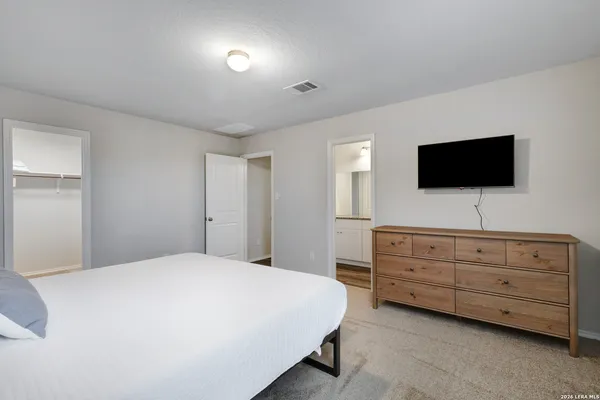 a bedroom with a bed and a flat screen tv