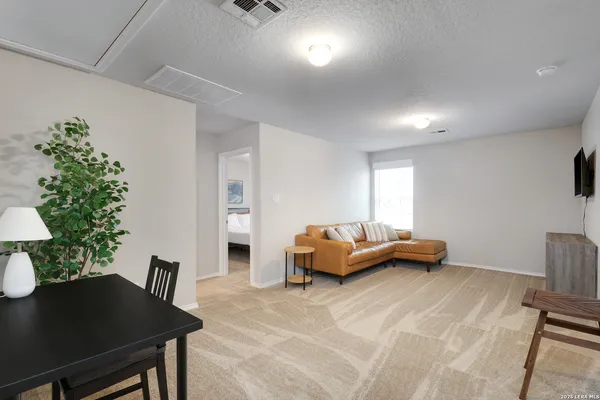 a living room with furniture flowerpot and a potted plant