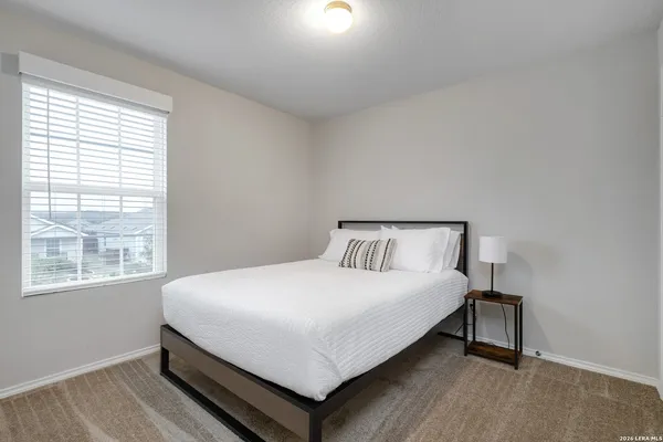 a bedroom with a bed and window