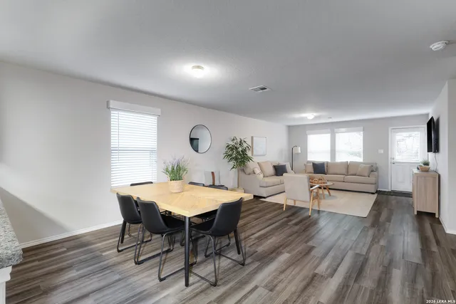 a view of a dining room with furniture and wooden floor