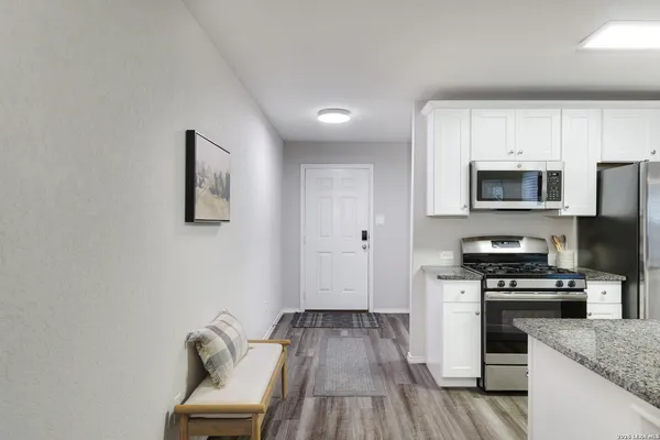 a kitchen with sink a microwave and cabinets