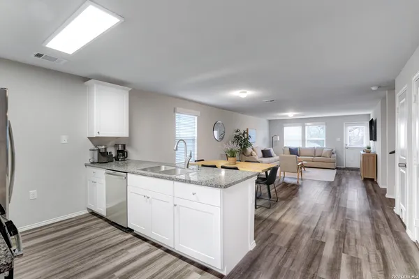 a kitchen with a sink stove and cabinets