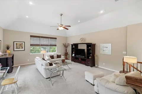 a living room with furniture and floor to ceiling window