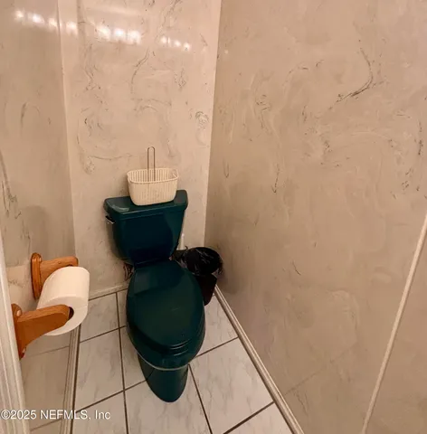 a spacious bedroom with a bed a fireplace and a television