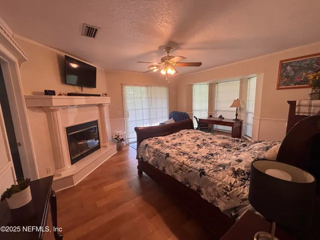 a bedroom with a bed and a fireplace
