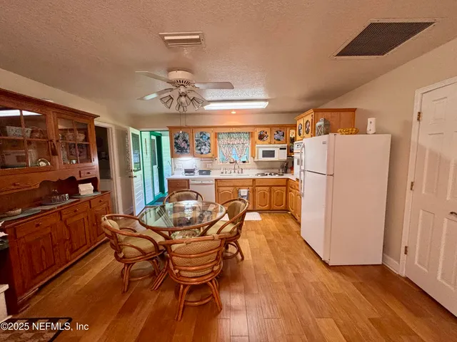 a kitchen with a stove a sink and a microwave