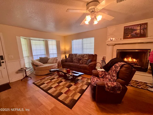 a hotel room with furniture a large window and a flat screen tv