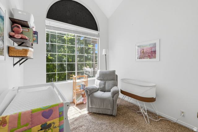 650 South Main Street, Unit 3304 Bountiful, UT 84010 - Photo 13 of 22 Room featuring a large arched window with grid detailing, white window blinds, and an upper arched shade