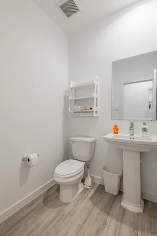 a bathroom with a sink toilet and a mirror