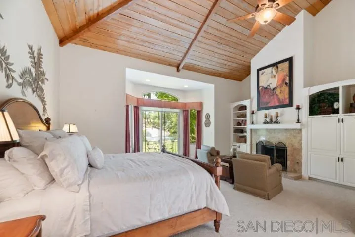 16163 Del Norte Poway, CA 92064 - Photo 6 of 22 a bedroom with a bed couch tv and window