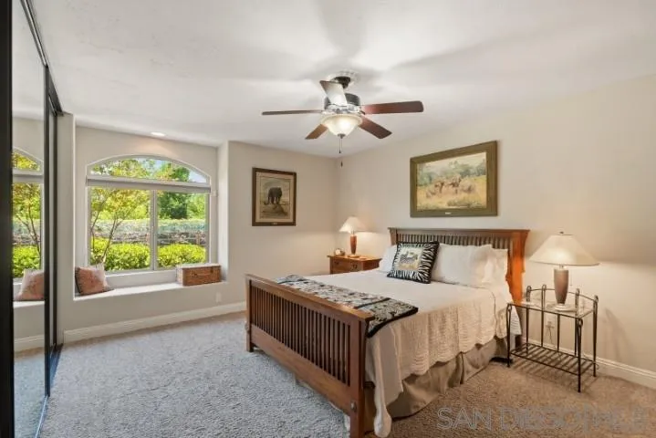 16163 Del Norte Poway, CA 92064 - Photo 9 of 22 a bedroom with a bed and a chandelier